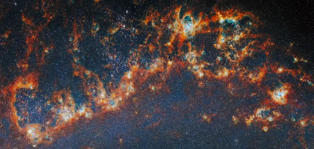 Detalle de un brazo espiral de la galaxia M51 con regiones de formación estelar observadas por Webb y Hubble